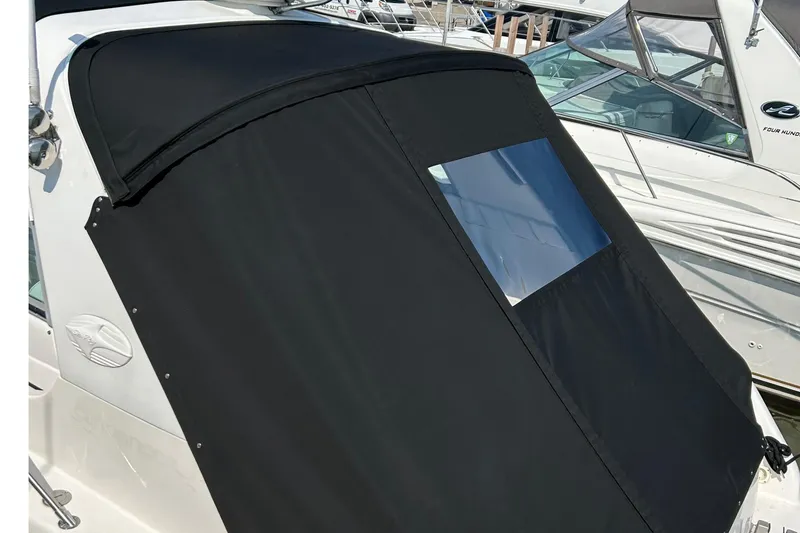 Slide: The Image of Black canvas cover on a 1996 Sea Ray boat with a clear window. - 14
