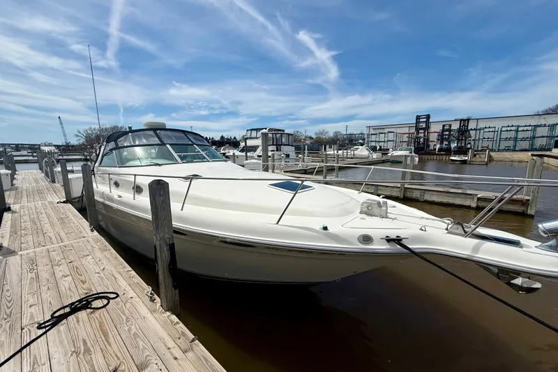 Slide: The Image of 1996 Sea Ray boat docked at marina under blue sky. - 2