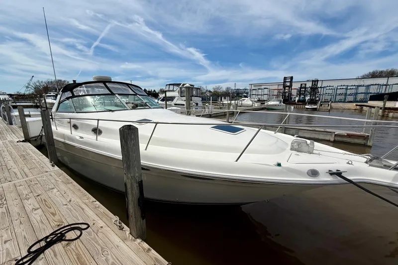 Slide: The Image of 1996 Sea Ray boat docked at marina under blue sky. - 6