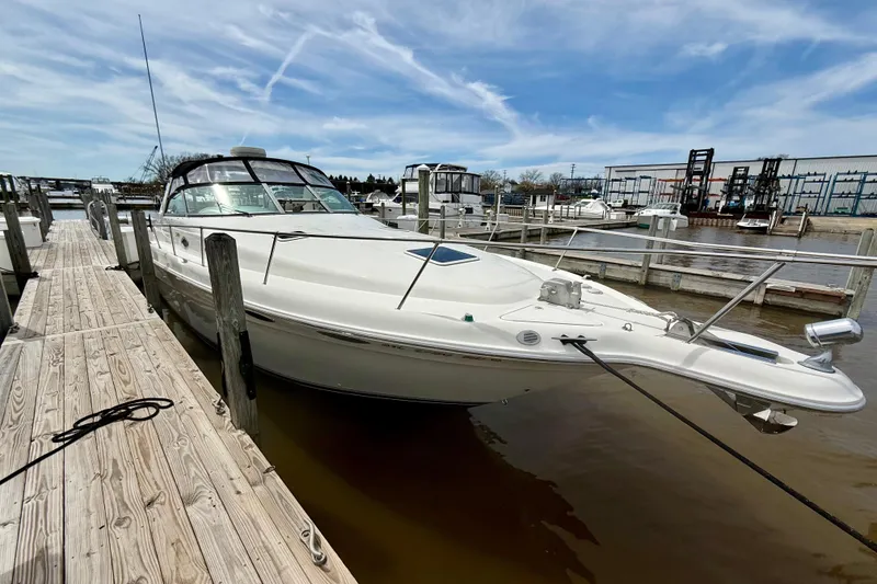 Slide: The Image of 1996 Sea Ray boat docked at marina under blue sky. - 8