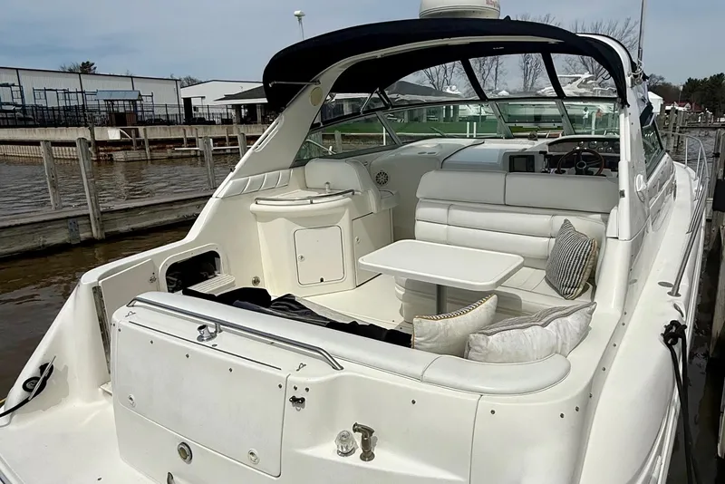 Slide: The Image of 1996 Sea Ray boat with white seating and table, docked at a marina. - 9