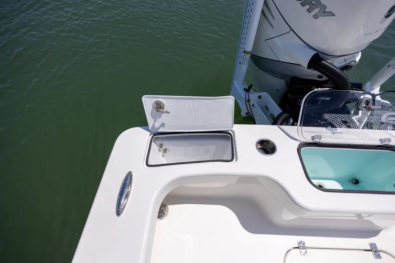 Slide: The Image of Open storage compartment on ZCB Freemason 26 boat, 2022 model, near outboard motor. - 15