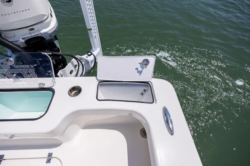 Slide: The Image of ZCB Freemason 26 boat stern with open hatch, motor, and water view. - 17