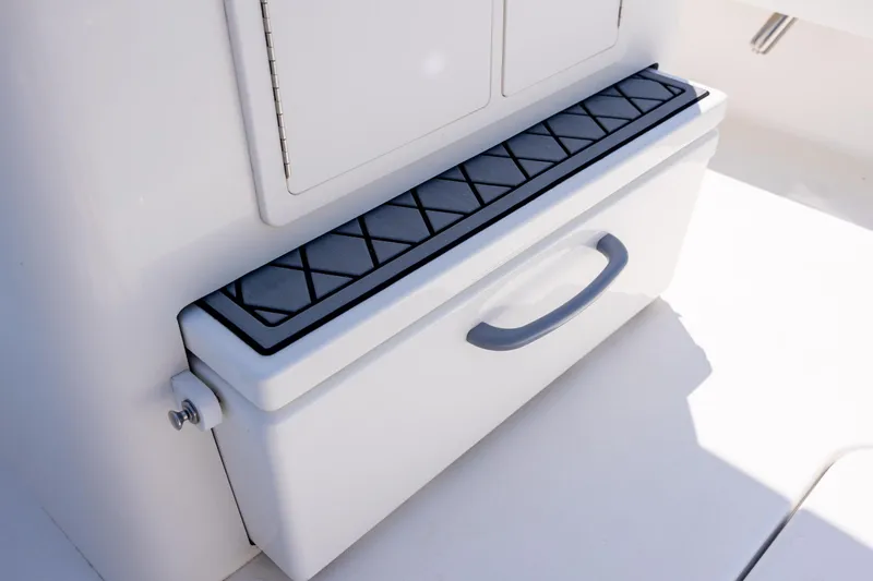 Slide: The Image of 2022 ZCB Freemason 26 boat storage compartment with textured lid and handle. - 23
