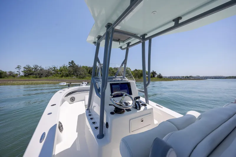 Slide: The Image of 2022 ZCB Freemason 26 boat navigating calm waters under clear blue sky. - 24