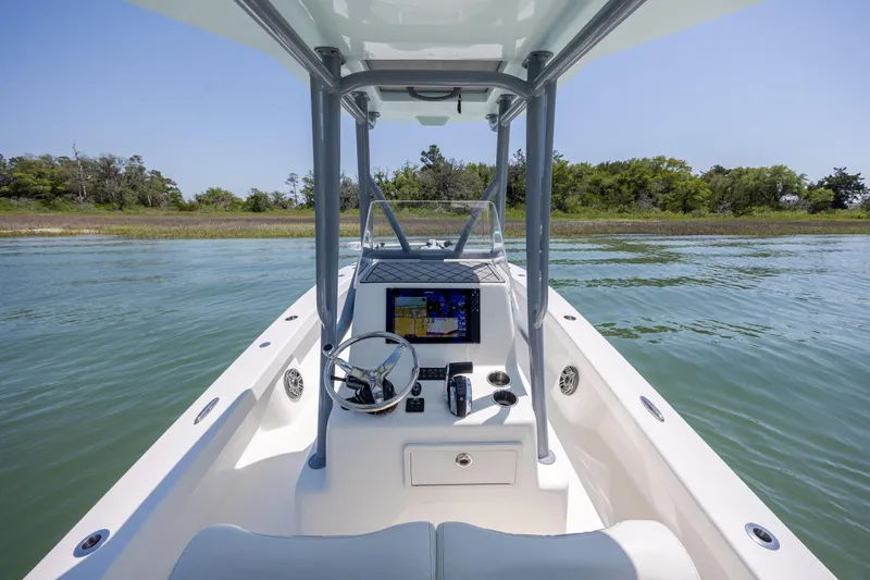 Slide: The Image of 2022 ZCB Freemason 26 boat interior with navigation system on calm water. - 25