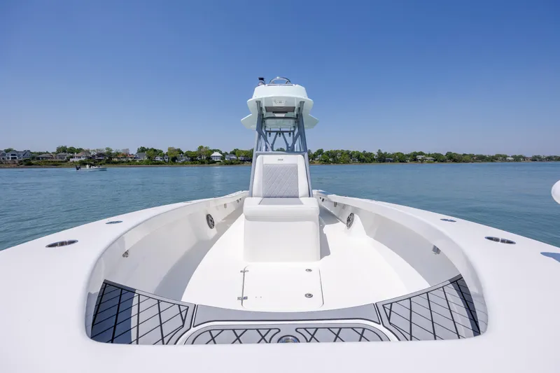 Slide: The Image of 2022 ZCB Freemason 26 boat on calm water, clear sky, and distant shoreline. - 36