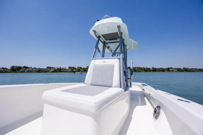 Slide: The Image of 2022 ZCB Freemason 26 boat on calm water, featuring sleek seating and clear blue skies. - 37