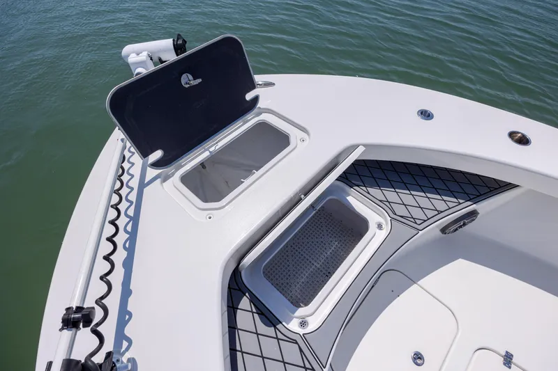 Slide: The Image of Open storage compartments on 2022 ZCB Freemason 26 boat deck, near water. - 38