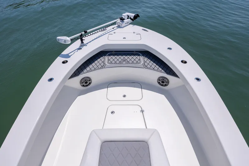 Slide: The Image of Bow of 2022 ZCB Freemason 26 boat with seating and storage on calm water. - 42