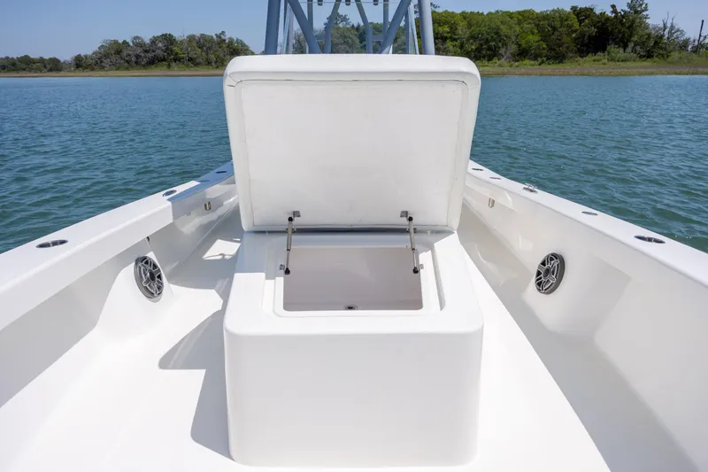 Slide: The Image of 2022 ZCB Freemason 26 boat with open storage compartment on calm water. - 46