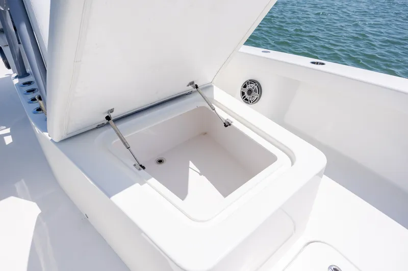 Slide: The Image of Open storage compartment on 2022 ZCB Freemason 26 boat, near water. - 47