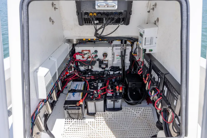 Slide: The Image of Electrical system inside a 2022 ZCB Freemason 26 boat, showcasing wiring and battery setup. - 48