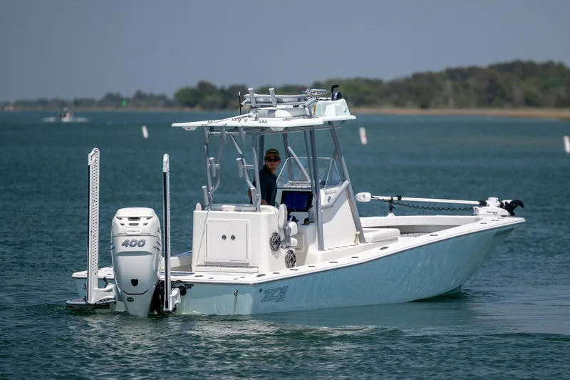 Slide: The Image of 2022 ZCB Freemason 26 boat cruising on a calm lake with a powerful outboard motor. - 6