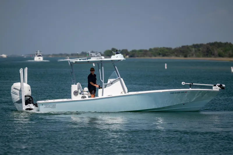 Slide: The Image of 2022 ZCB Freemason 26 boat cruising on calm waters with a person onboard. - 8