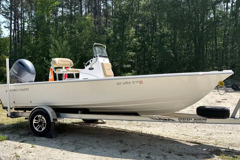 The Image of 2017 Sportsman Masters 207 Bay Boat on trailer in wooded area. - 1
