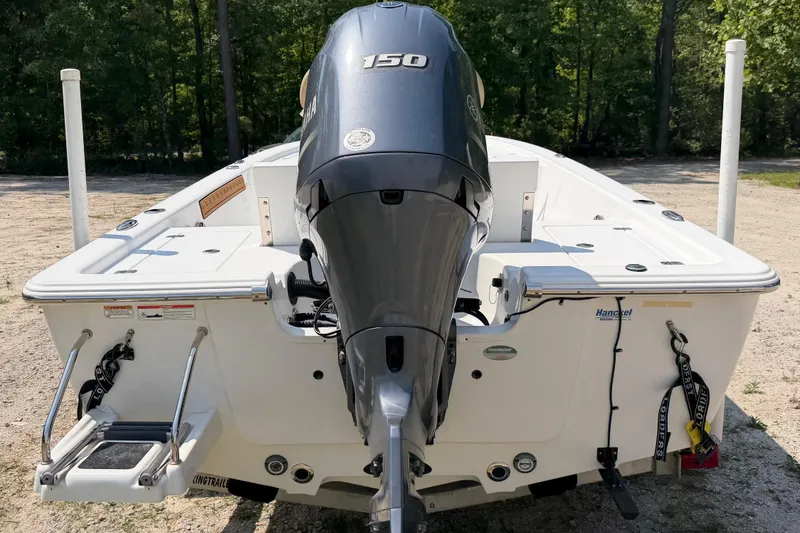 Slide: The Image of 2017 Sportsman Masters 207 Bay Boat with Yamaha outboard motor, parked on a sandy area. - 5
