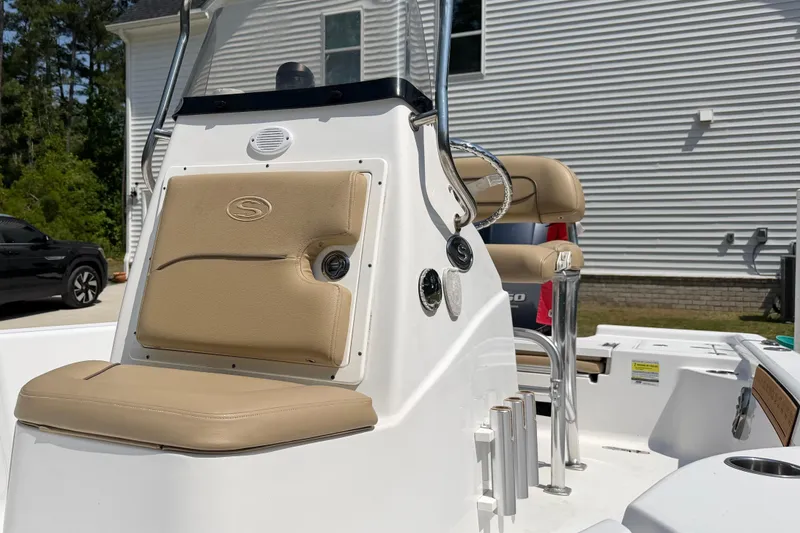 Slide: The Image of 2017 Sportsman Masters 207 Bay Boat interior with beige seating and console. - 7
