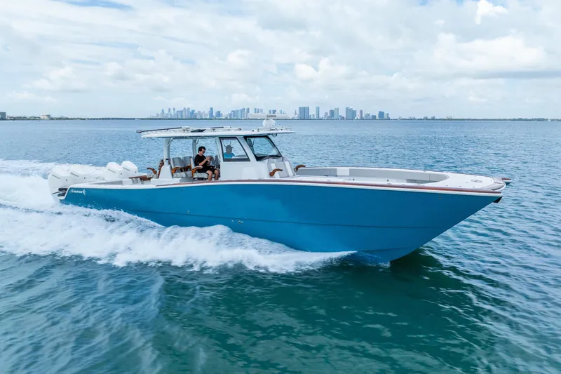 The Image of 2024 Freeman 47 boat cruising on open water with city skyline in background. - 0