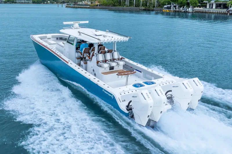 Slide: The Image of 2024 Freeman 47 boat cruising on blue water with powerful Mercury engines. - 10