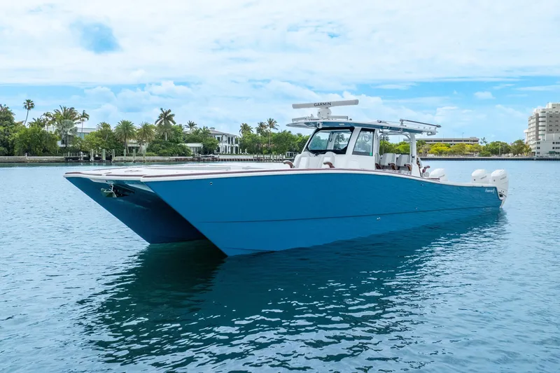 Slide: The Image of 2024 Freeman 47 boat on calm water, featuring a sleek blue design. - 17