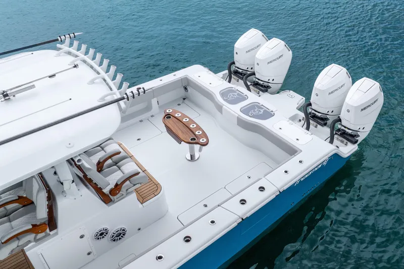 Slide: The Image of 2024 Freeman 47 boat with four Mercury engines on blue water. - 19