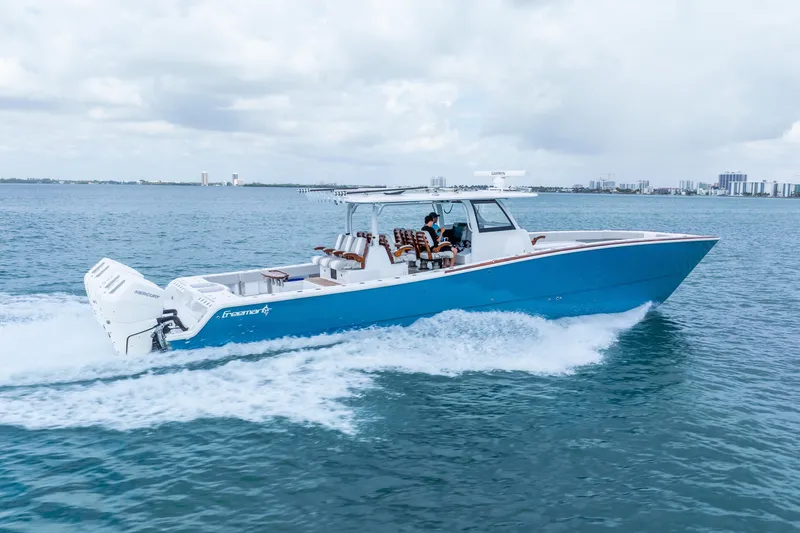 Slide: The Image of 2024 Freeman 47 boat cruising on open water, showcasing sleek design and powerful engines. - 2