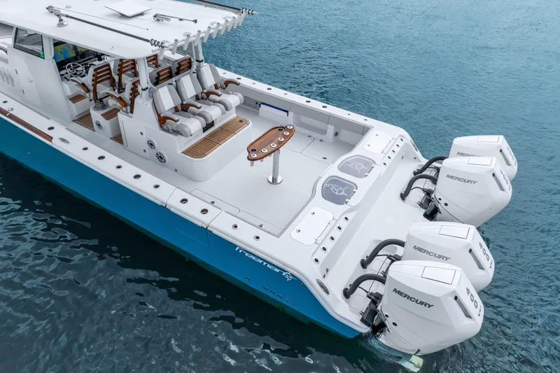 Slide: The Image of 2024 Freeman 47 boat with Mercury engines on blue water. - 20