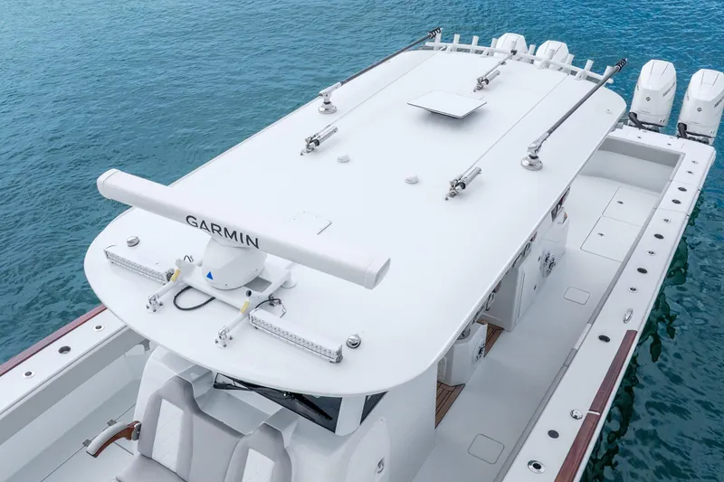 Slide: The Image of 2024 Freeman 47 boat with Garmin radar, docked on clear blue water. - 21