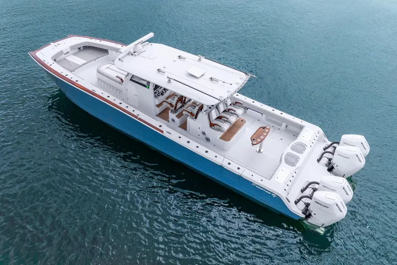 Slide: The Image of 2024 Freeman 47 boat with triple Mercury engines on calm water. - 23