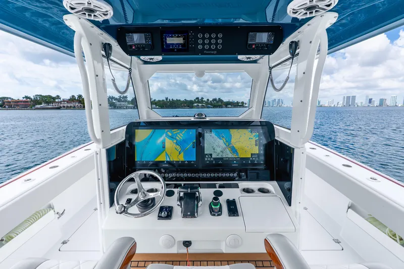 Slide: The Image of 2024 Freeman 47 boat cockpit with advanced navigation system on open water. - 24