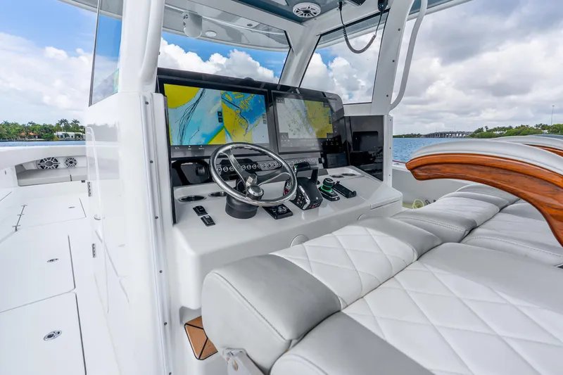 Slide: The Image of 2024 Freeman 47 boat cockpit with advanced navigation screens and luxurious seating. - 26