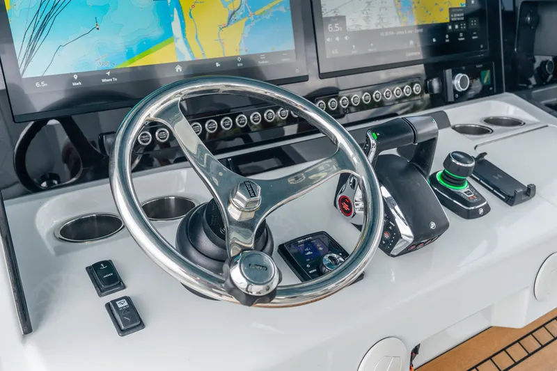 Slide: The Image of Steering console of 2024 Freeman 47 boat with navigation screens and controls. - 27
