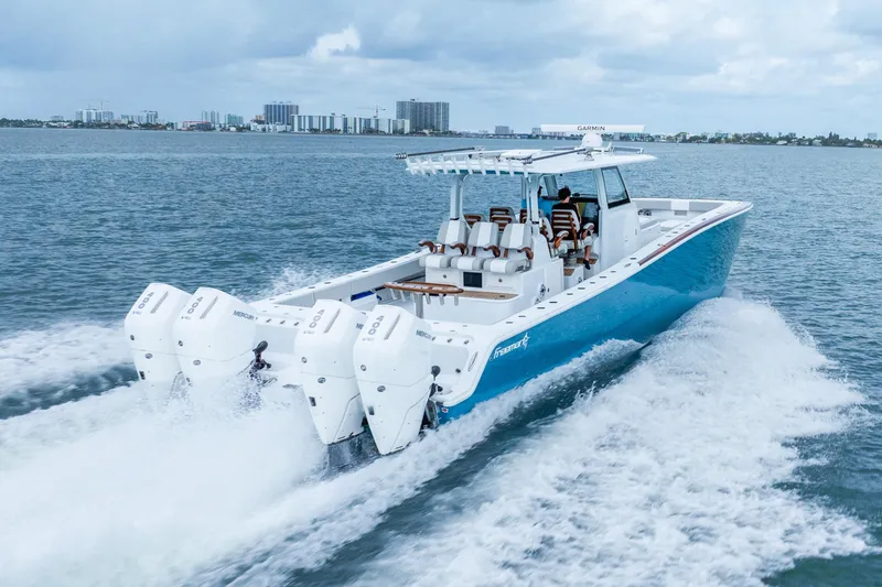 Slide: The Image of 2024 Freeman 47 boat cruising on water with four powerful engines. - 3