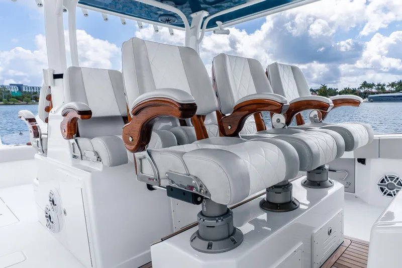 Slide: The Image of Luxurious seating on a 2024 Freeman 47 boat, featuring elegant white and wood accents. - 30