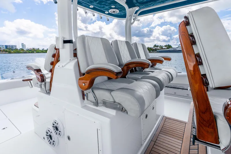 Slide: The Image of Luxurious seating on 2024 Freeman 47 boat with elegant wood accents and waterfront view. - 31
