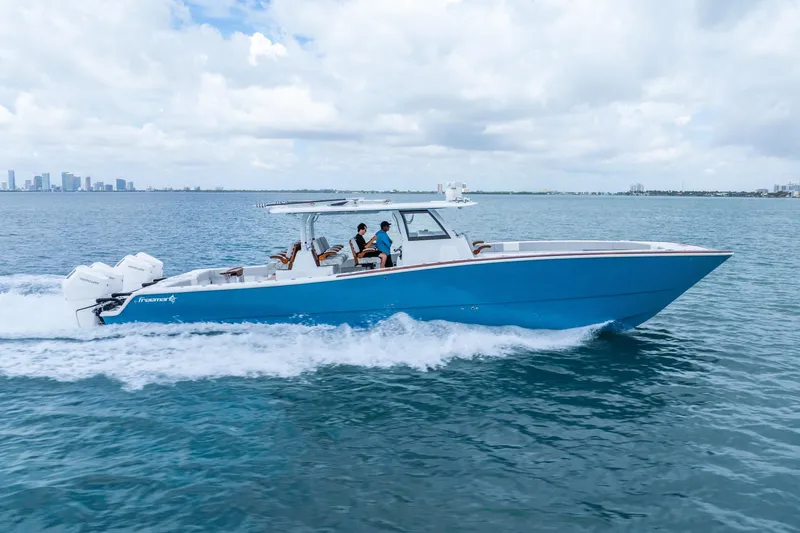 Slide: The Image of 2024 Freeman 47 boat cruising on open water under a cloudy sky. - 4