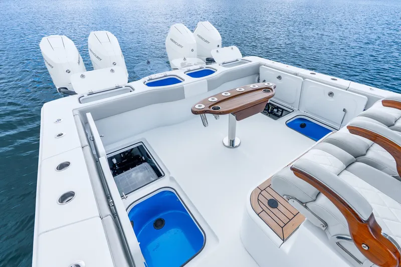 Slide: The Image of Luxurious 2024 Freeman 47 boat deck with seating, fishing rod holders, and multiple outboard engines. - 48