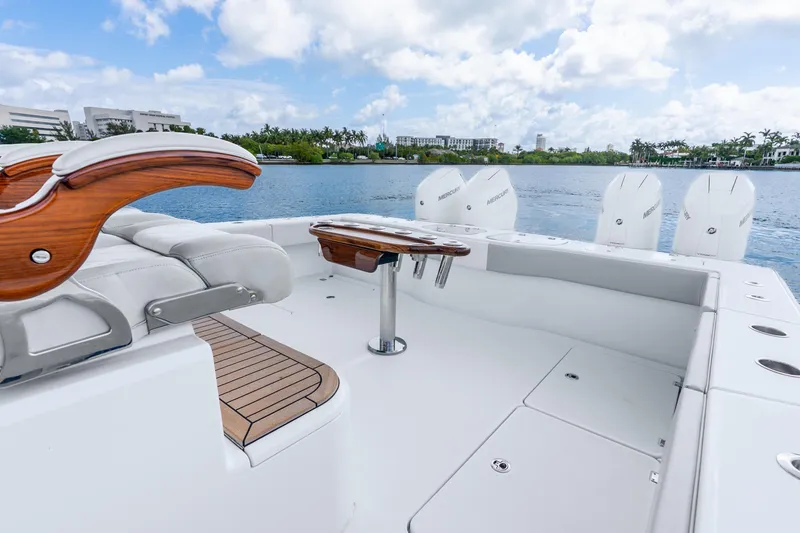 Slide: The Image of Luxury Freeman 47 boat interior with seating and outboard motors, 2024 model, on a scenic waterway. - 49