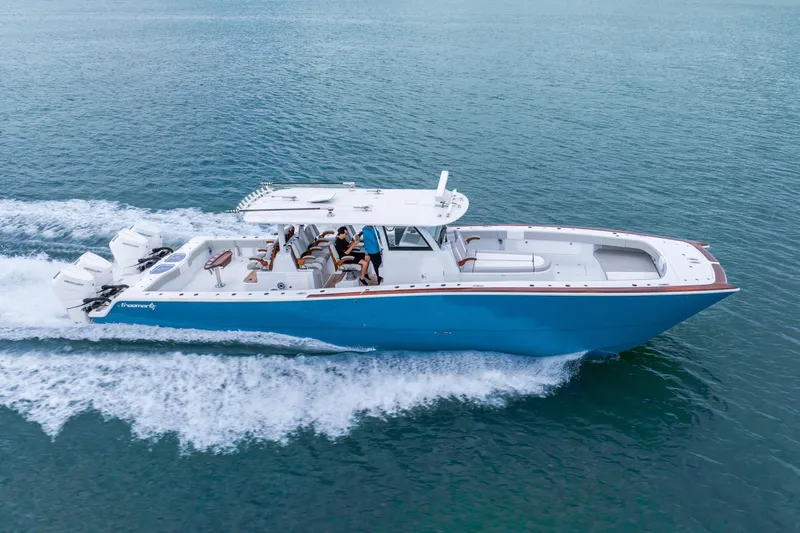 Slide: The Image of 2024 Freeman 47 boat cruising on open water, showcasing sleek design and powerful engines. - 5