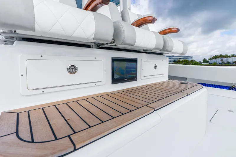Slide: The Image of Luxury seating and dashboard on 2024 Freeman 47 boat, featuring wood accents and navigation display. - 51