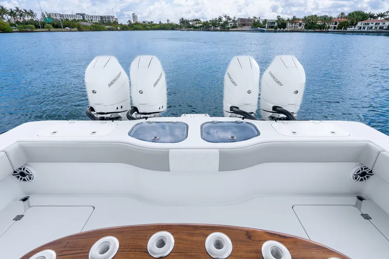 Slide: The Image of 2024 Freeman 47 boat with four Mercury engines on a calm lake. - 52