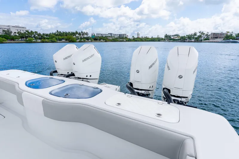 Slide: The Image of 2024 Freeman 47 boat with four Mercury outboard engines on a serene waterway. - 53