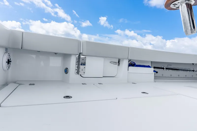 Slide: The Image of 2024 Freeman 47 boat deck with storage compartments under a clear blue sky. - 54