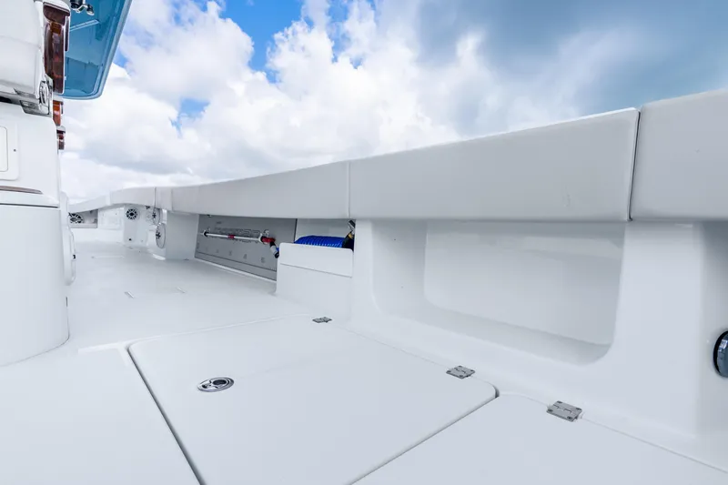 Slide: The Image of 2024 Freeman 47 boat deck with sleek design under a bright blue sky. - 55