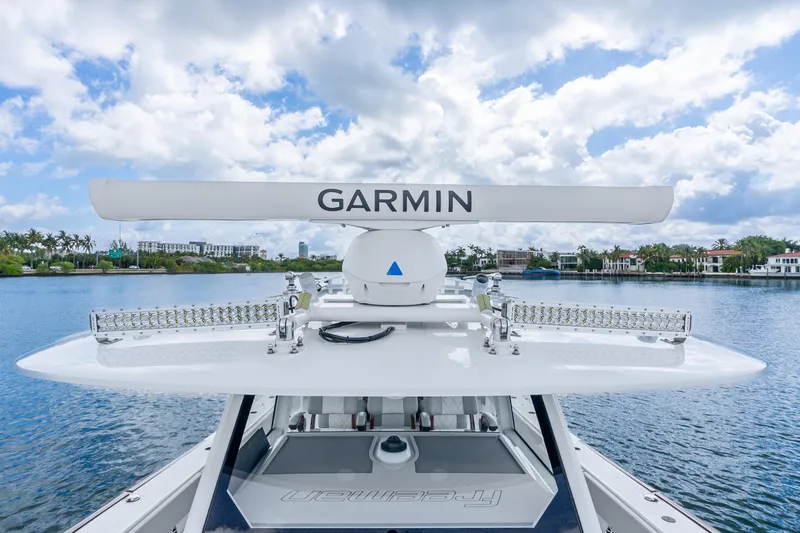 Slide: The Image of Freeman 47 boat with Garmin radar, 2024 model, on a scenic waterfront. - 60