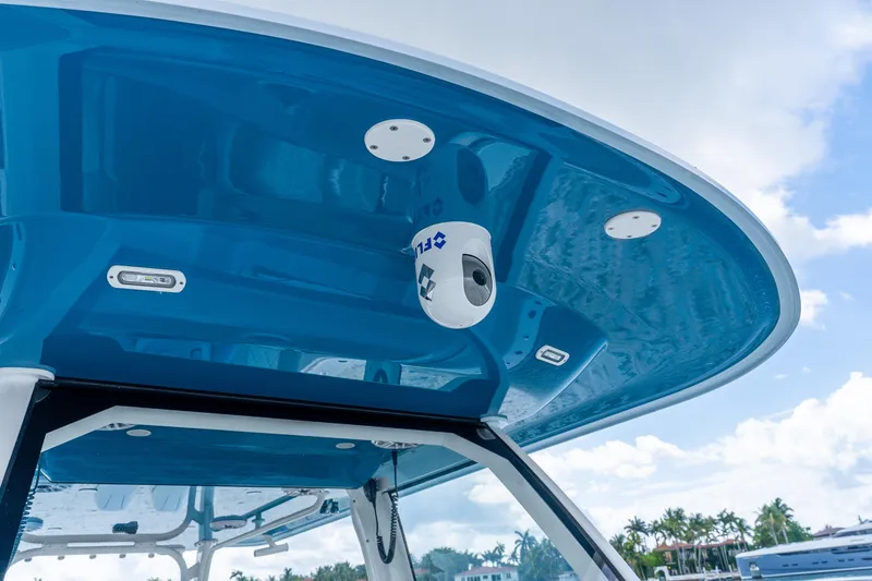 Slide: The Image of 2024 Freeman 47 boat with blue canopy and mounted camera system. - 61