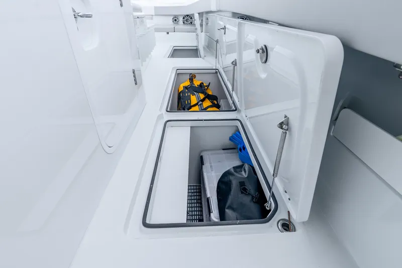 Slide: The Image of Storage compartments on a 2024 Freeman 47 boat, featuring safety gear and equipment. - 67