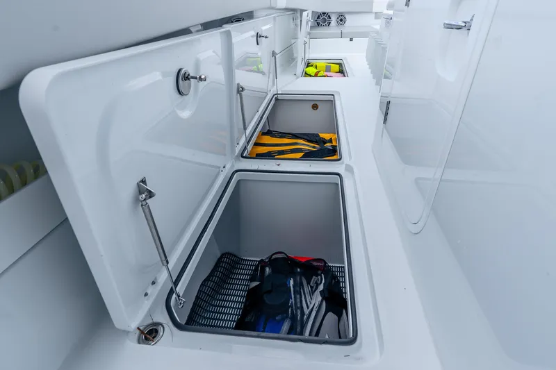 Slide: The Image of Open storage compartments on a 2024 Freeman 47 boat, showcasing organized gear storage. - 68