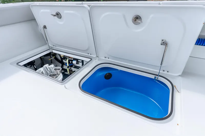 Slide: The Image of Open compartments on a 2024 Freeman 47 boat, showcasing storage and equipment. - 69